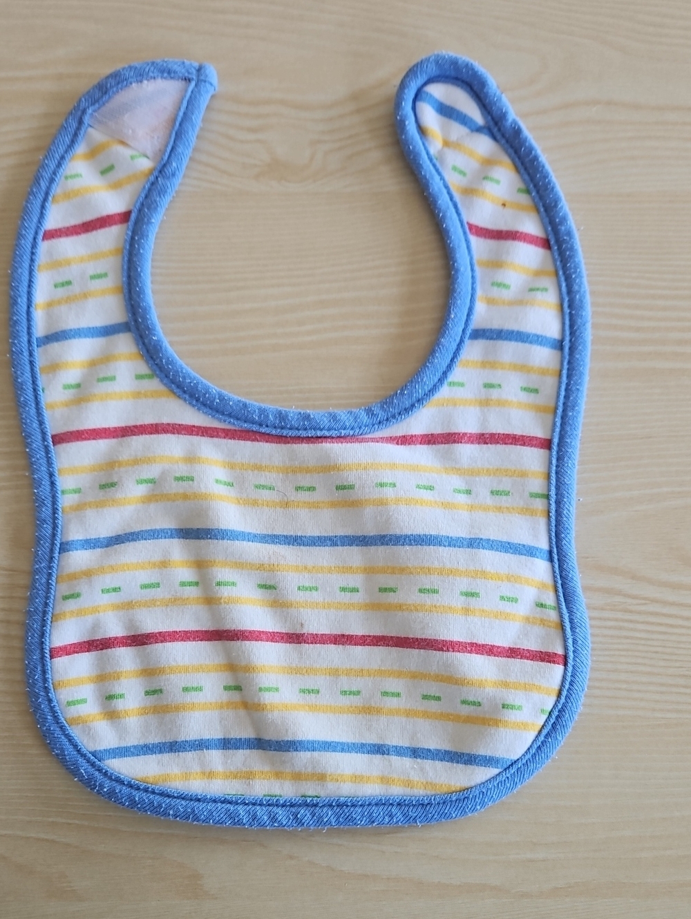 BabiesRUs Striped Bib with Blue Trim and Multicolor Lines